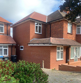 Double storey side extension with pitched roof and raised driveway Project image