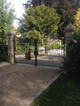 New granite set driveway with stone piers and automated gate system Project image