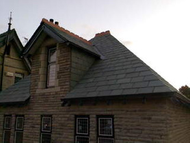 Random diminishing Green Slate Roof with mitred hips and vertical slating Project image