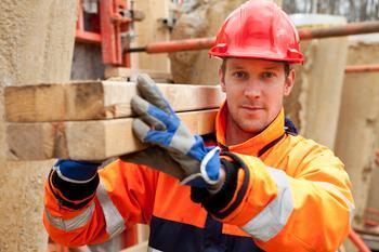 Image of man carrying wood 