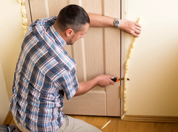 iStock-retrofit-green-initiative-man-installing-insulation-foam-door-2000W.png