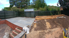 Patio and raised sleeper flowerbed on the top section ready for pointing and filling with soil. Project image
