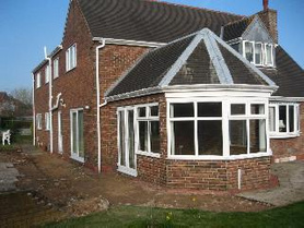 enlargement of sunroom/conservatory. Before and after. Project image