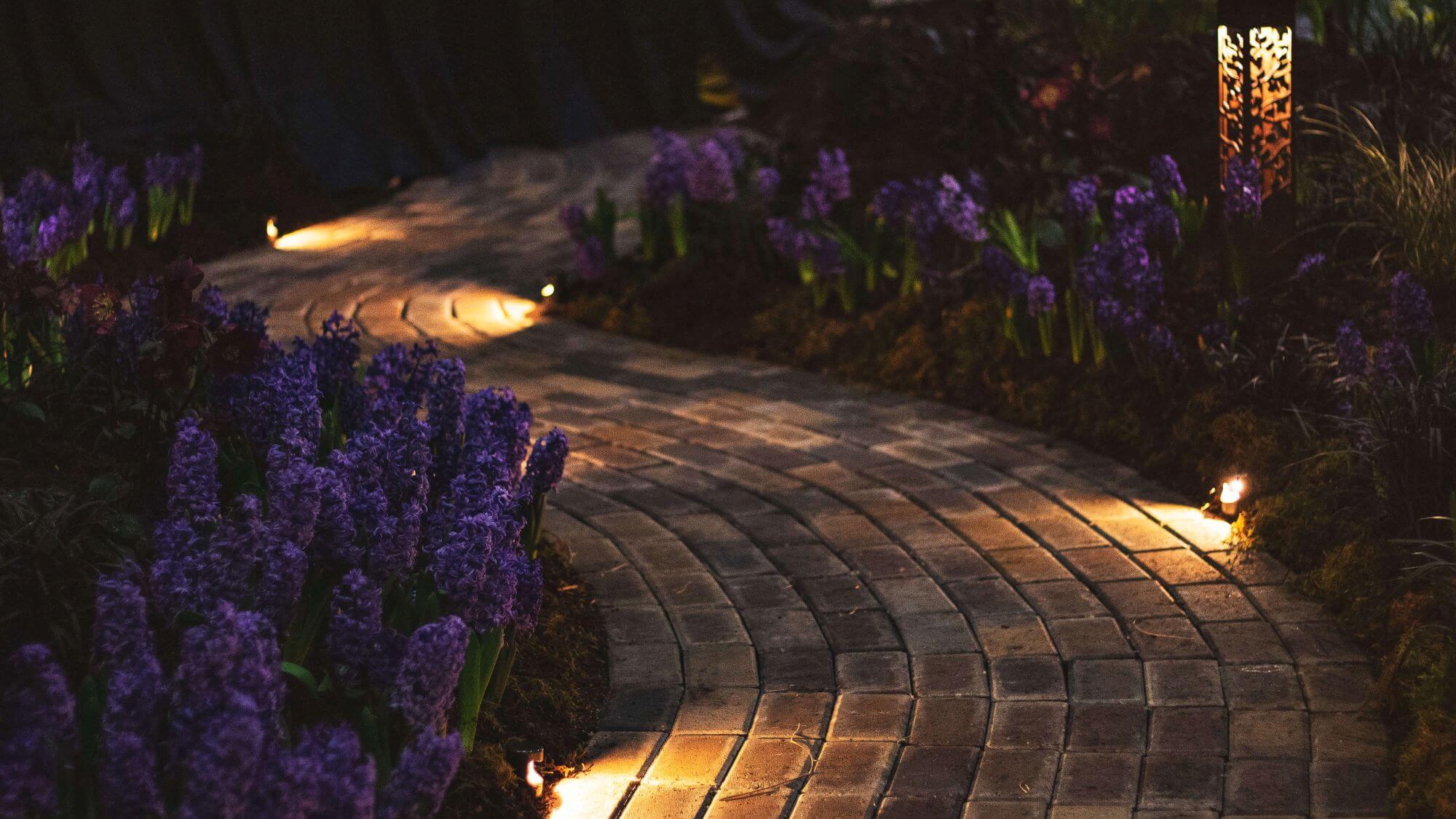 brickwork garden path illuminated by night