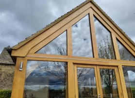 A Cotswold block conservatory base ,with oak windows and doors with a apex window on top of the doors, Project image
