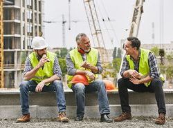 iStock builders collaborate group smiling site.jpg