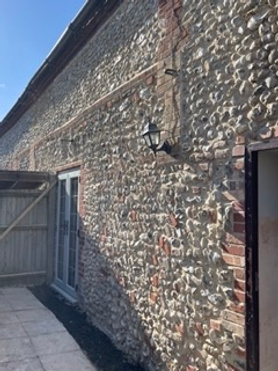 Repairing & repointing a flint wall to prepare for a small extension build Project image