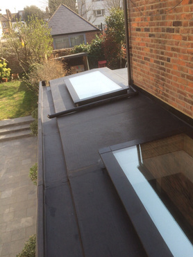 EPDM side extension Rendered walls with copings and artificial grass laid. Project image