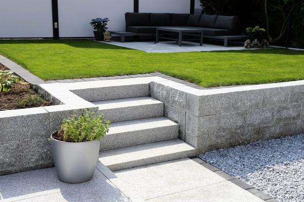 Concrete block retaining wall in a simple lawned garden