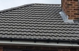 Replacement flat felt roof to side elevation, replacement main roof ridge tiles, chimney pointing and new lead flashing to chimney breast Project image