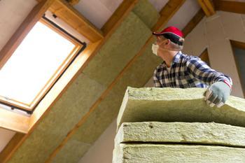 Man fitting insulation