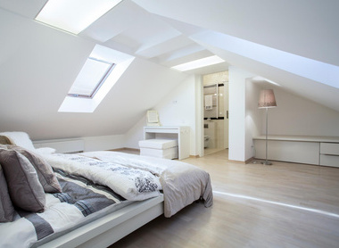 Beautiful airy loft conversion bedroom with white walls and large windows