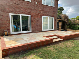 Natural sandstone patio & retaining brickwork platform Project image