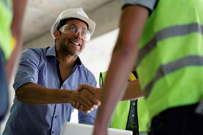 Builder shaking hands on a public sector contract.jpg
