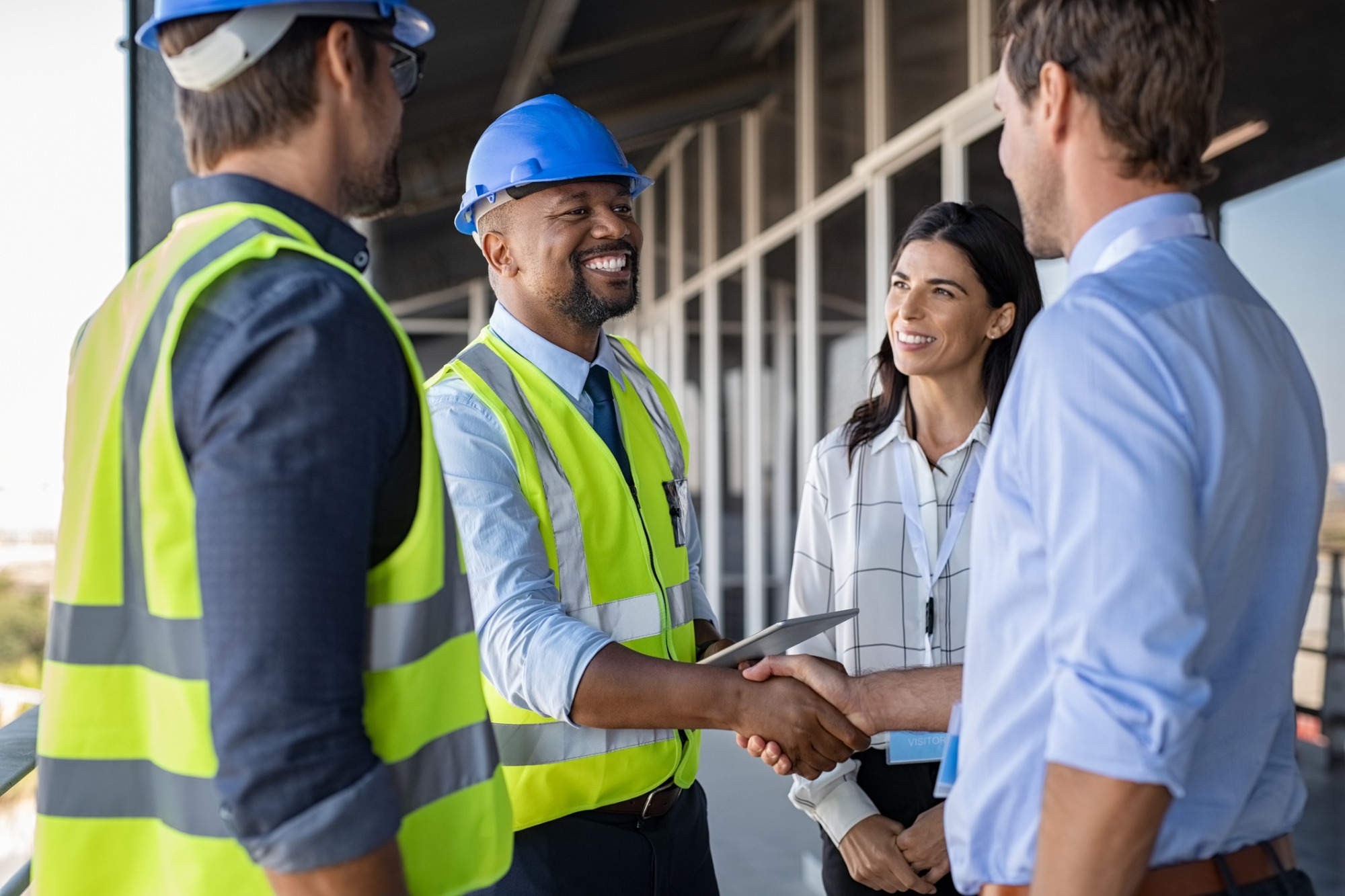 engineer-and-businessman-handshake-at-construction-site-picture-id1189913170.jpg