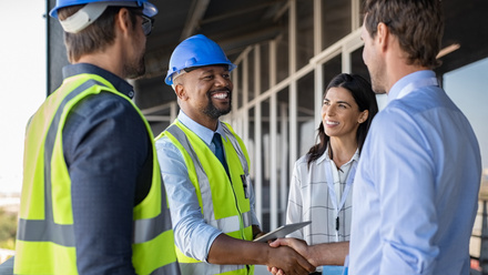 engineer-and-businessman-handshake-at-construction-site-picture-id1189913170.jpg